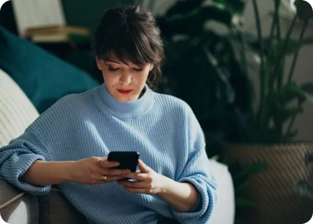 A driver looking up local repair shops on her phone
